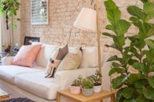 a cozy living room with a muted brick wall that is textural yet rather soft-looking