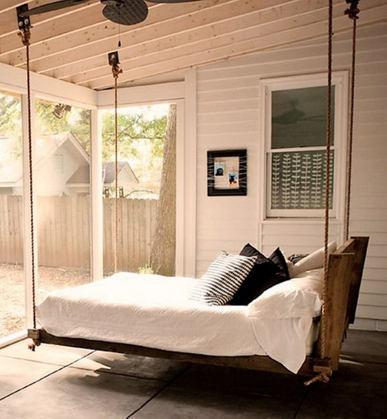 a hanging bed of wood and rope, with neutral bedding and printed pillows will let you relax a bit