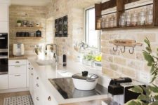 a modern farmhouse kitchen with whitewashed bricks, white cabinets and chic countertops looks very cozy