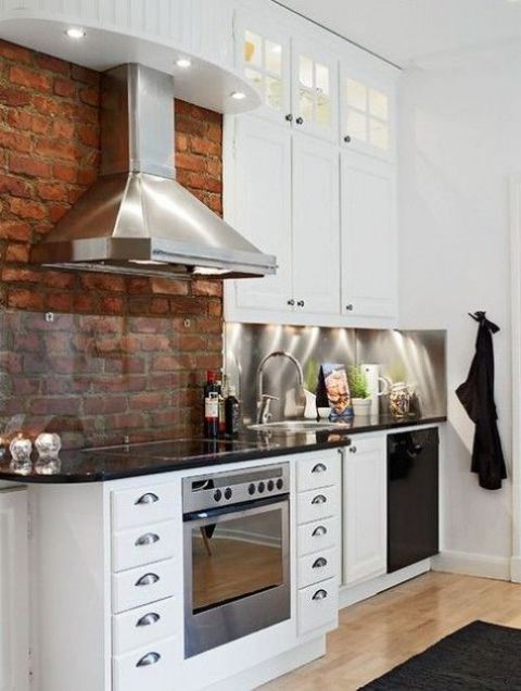 a red brick wall with a backsplash covered with glass to make cleaning more comfortable