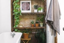 a touch of brick and potted greenery make the bathroom really eye-catching and really cool