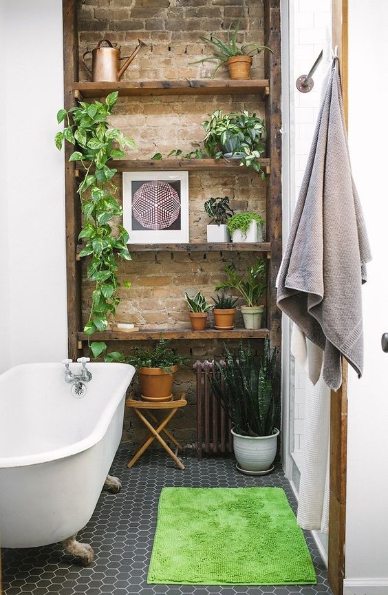 A touch of brick and potted greenery make the bathroom really eye catching and really cool