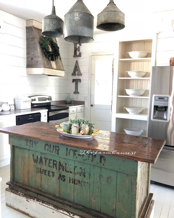 A vintage industrial kitchen island of wood with a green base of crates that looks very eye catchy