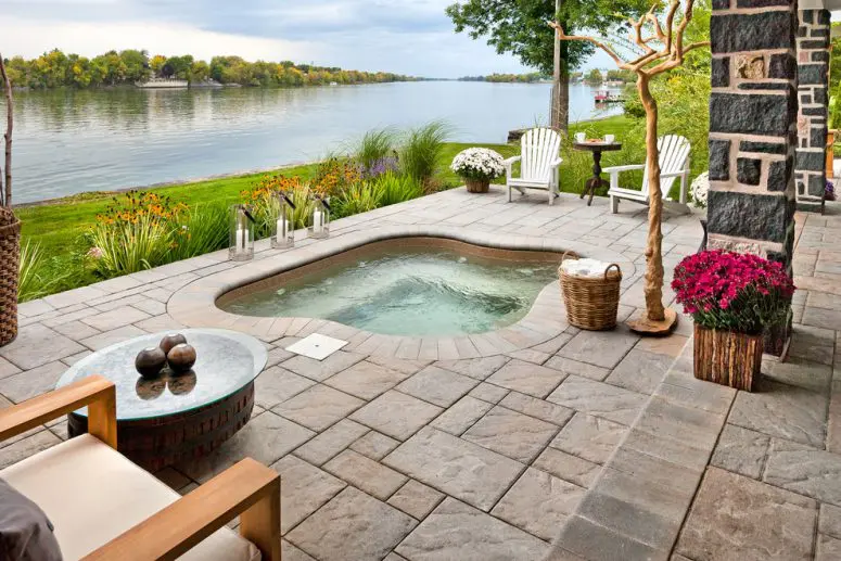 an amazing patio by the river should definitely feature an in-deck hot tub ( Marshall Stone)
