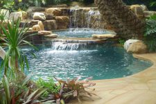 even a tropical pool would become more amazing if you add a waterfall to it