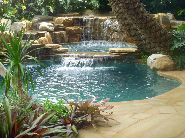 even a tropical pool would become more amazing if you add a waterfall to it