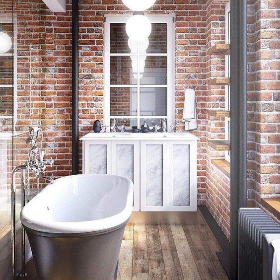 red brick walls and a wooden floor make an amazing combo, and a vintage tub and vanity add chic
