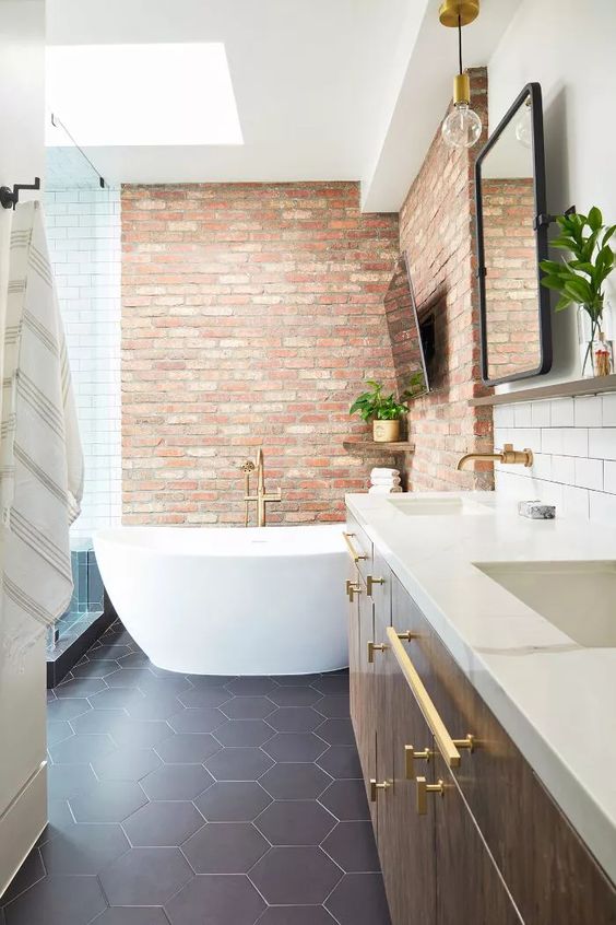 red bricks highlight the bathtub space making it stand out in white and navy bathroom and look bolder