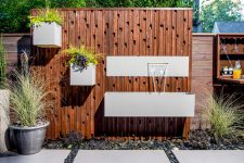 this is a very interesting solution to upgrade your fence with planters and waterfalls