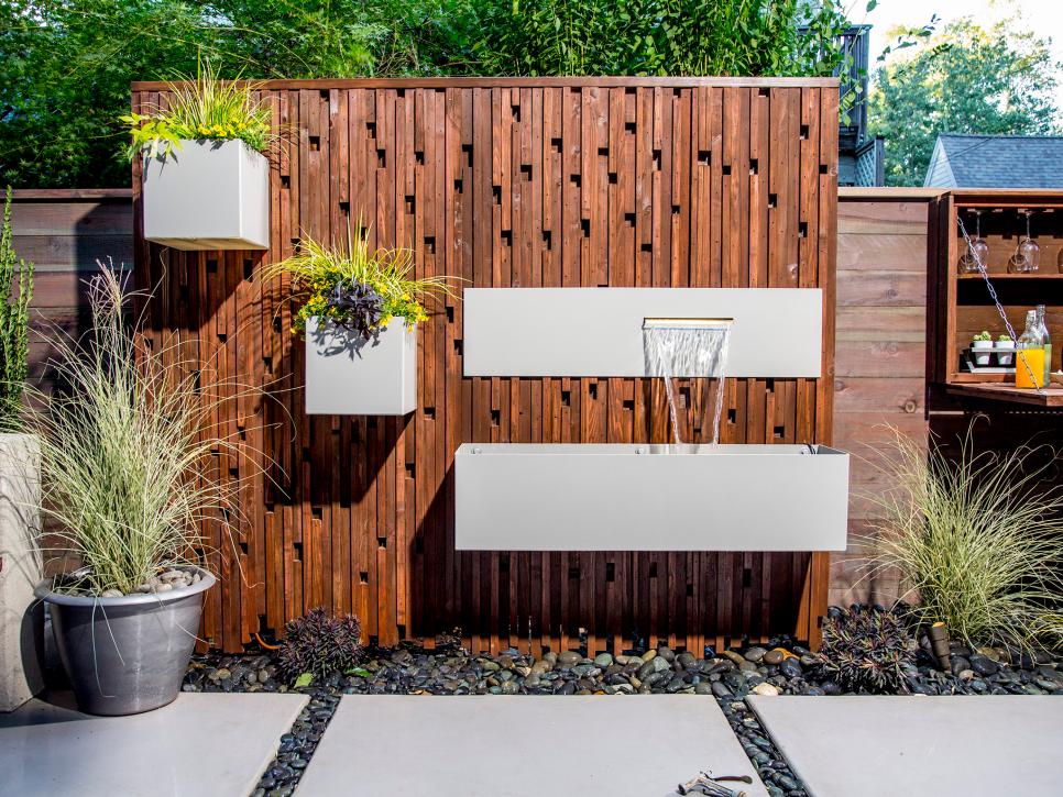This is a very interesting solution to upgrade your fence with planters and waterfalls