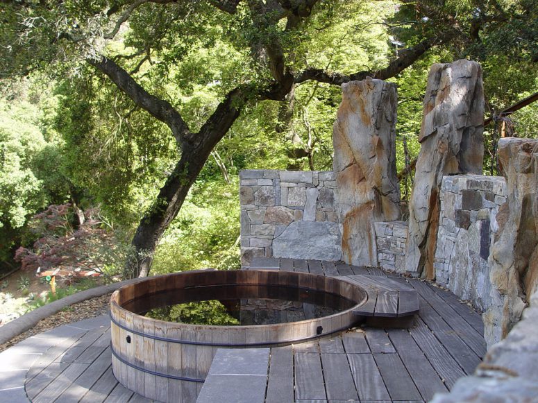 this rustic deck is a great example of how well a stone wall match a redwood hot tub tucked among the tree  (Simmonds &amp; Associates, Inc.)