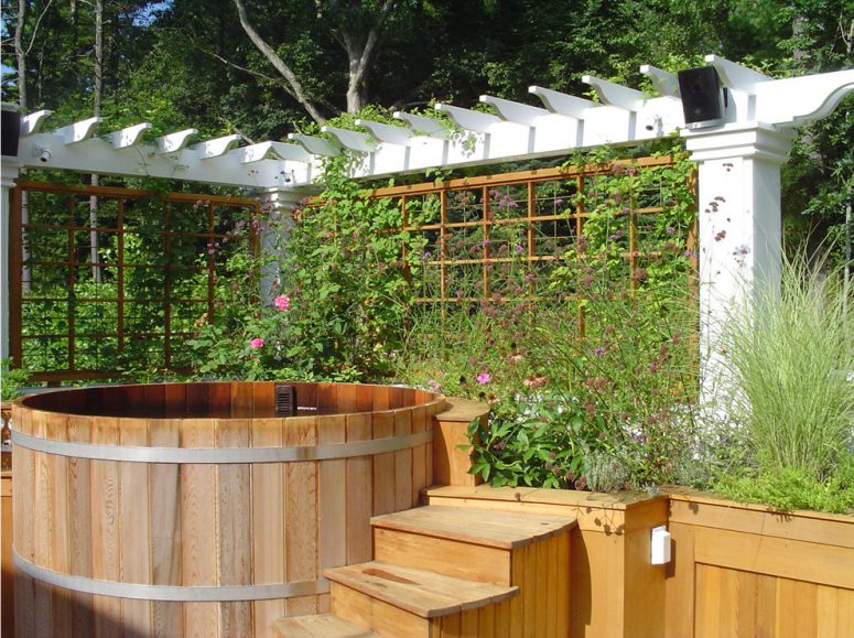 trellises on two sides of this wooden hot tub could help to create a flowering privacy screen