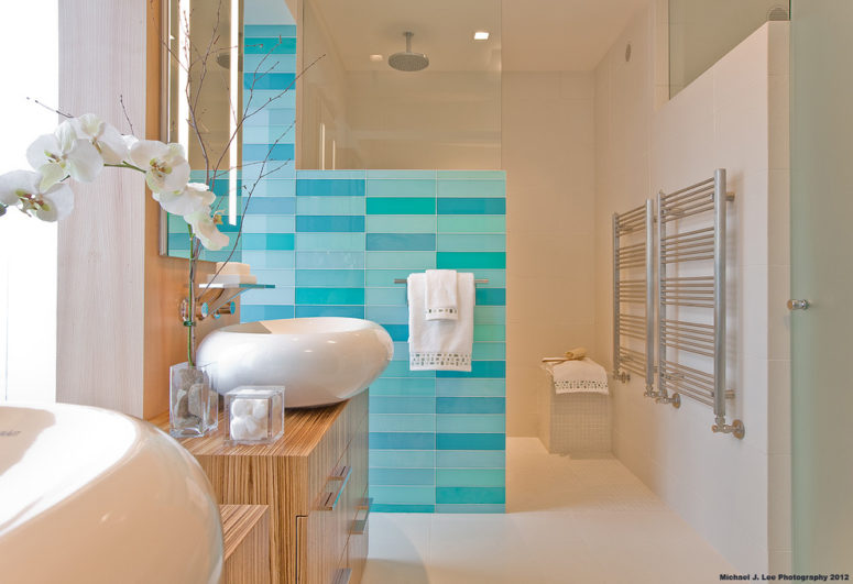 a luxurious sea-inspired bathroom in neutrals and blue and turquoise tile wall plus orchids  (Light Positive)