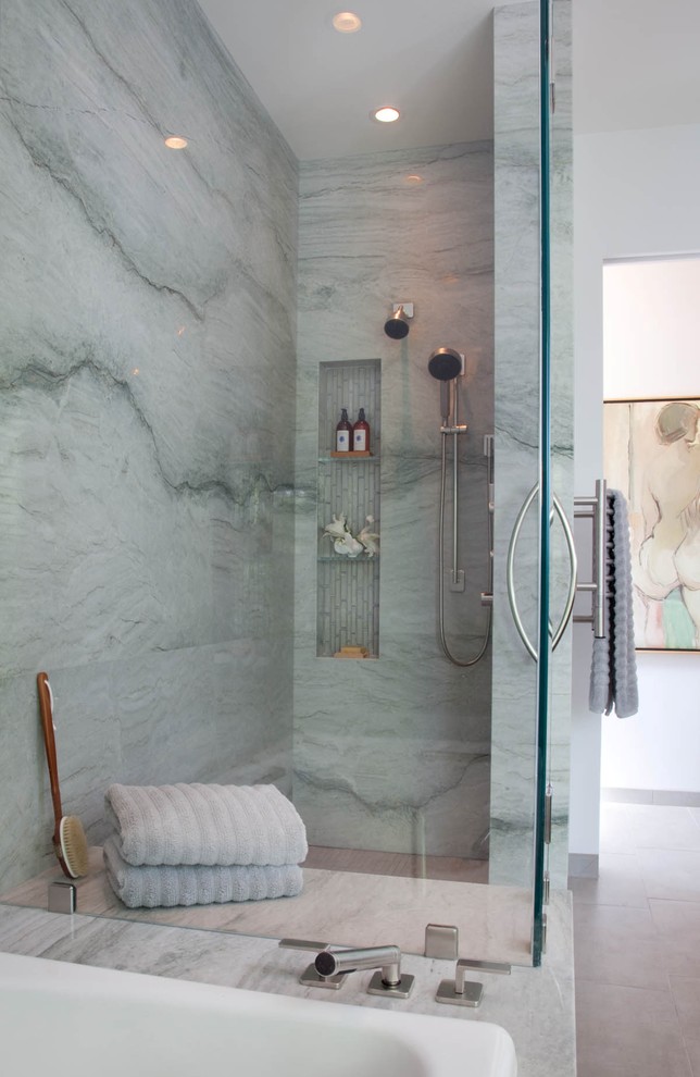 a blue stone shower space with a niche for storage, blue towels and touches of wood  (Reveal Studio)