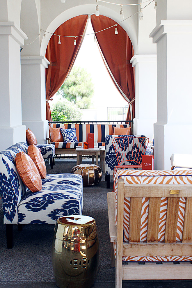a colorful patio styled wit bright colors and Moroccna prints plus a polished metal stool  (ReStyle Group Interiors)