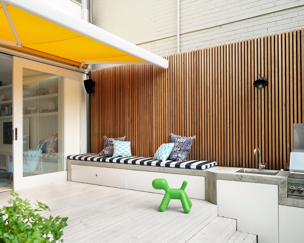 A concrete bench combined with a barbecue and a sink is an interesting space saving idea.