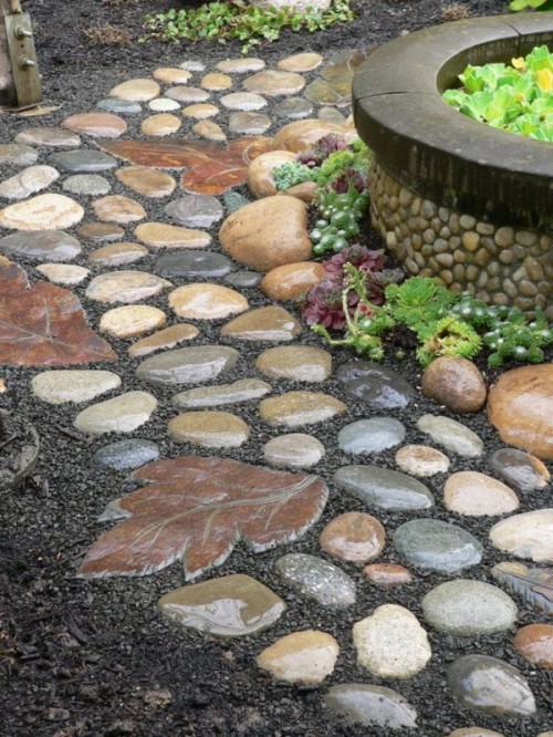 a catchy stone garden path with round muted color stones and leaf-shaped stones