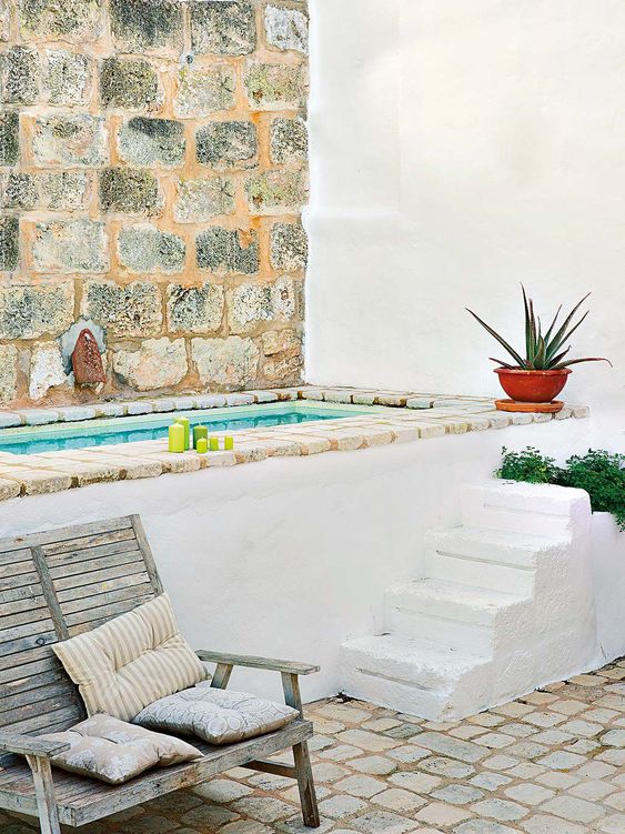 a cool Mediterranean outdoor bathroom with a stairs, planters, bricks and a shabby chic bench