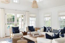 a preppy coastal living room with rattan lampshades, jute ottomans, stripes and traditional furniture