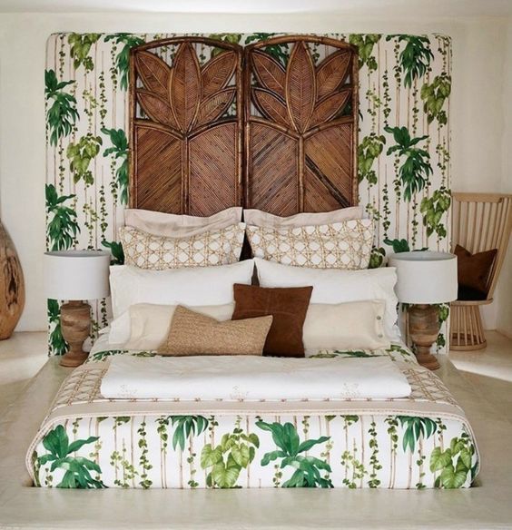 a whimsical tropical bedroom with carved wooden screens, touches of wood and rattan, tropical bedding and wooden lamps