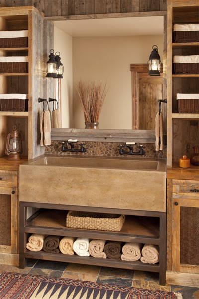a rustic meets modern bathroom of wood and tiles, with shelves on each side and a large metal sink (Studio Architects)