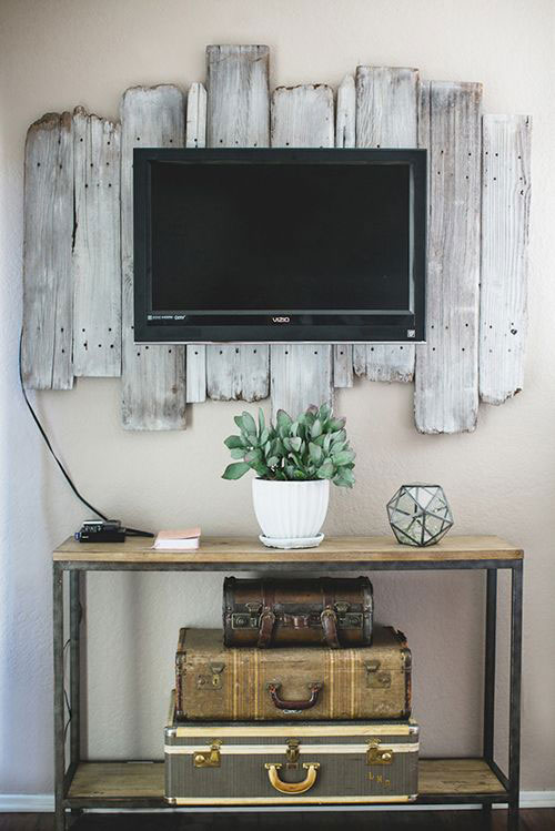 Here is a cool idea showing how you could mount a TV in a rustic chic bedroom.