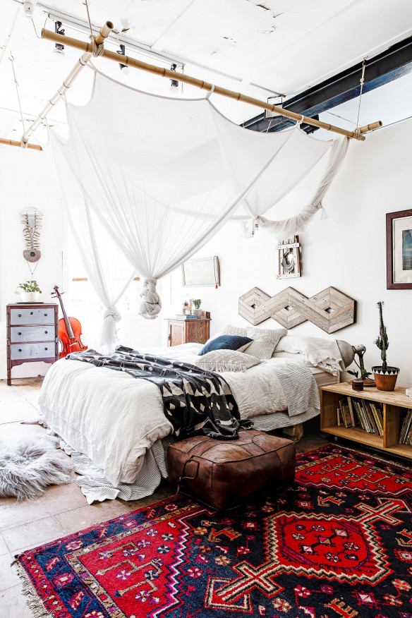 A bold, bright rug mixed with a creative but subtle canopy make this bedroom's decor quite unique.