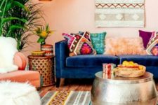 a bright Moroccan living room with colorful textiles and patterns, a hammered coffee table and lamps