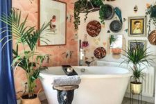 a bright bathroom with a wallpaper wall, boho rugs, decorative baskets, potted plants and artworks
