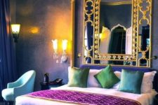 a colorful Moroccan bedroom in purple, blue and emerald, with gold touches and a framed mirror is a fersh take on Eastern bedrooms