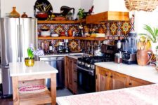 a colorful mosaic tile backsplash, a wicker lampshade and wooden cabinets for a boho feel