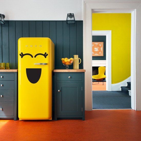 a hunter green kitchen with a bold yellow Smeg fridge looks extra bold and fun, it's pure modern chic