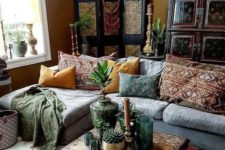 a modern Moroccan living room with Moroccan lamps, a patterned coffee table and pillows and rugs