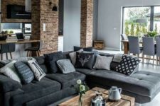 a modern rustic living room with a wood slab table and brick walls and a brick arch is veyr stylish