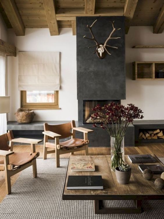 A modern rustic space with a built in fireplace and firewood storage, a jute rug, sleek wooden furniture with leather