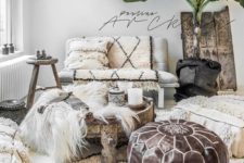a neutral Moroccan living room with lots of patterned textiles, a leather ottoman and a potted palm