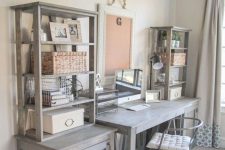 a rustic home office with pale furniture, open storage units, a metal chair for an industrial feel