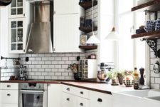 a vintage-inspired Nordic kitchen with a ceiling shelf, white tiles, white vintage cabinets and rich-stained countertops