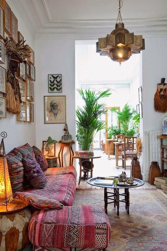 a welcoming and relaxing boho living room with Moroccan lamps, tassels and colorful textiles