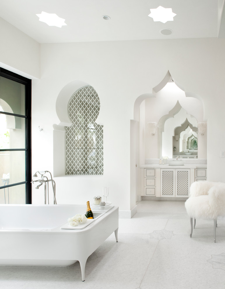 a pure white bathroom with star-shaped skylights, a tiled niche and a cutout doorway plus a carved vanity  (Gordon Stein Design)
