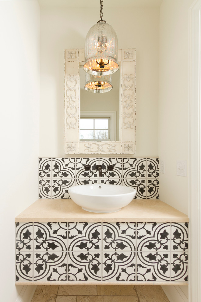 an antique glass pendant light, a built-in vanity clad with Moroccan black and white tiles and a bowl sink  (w.b. builders)