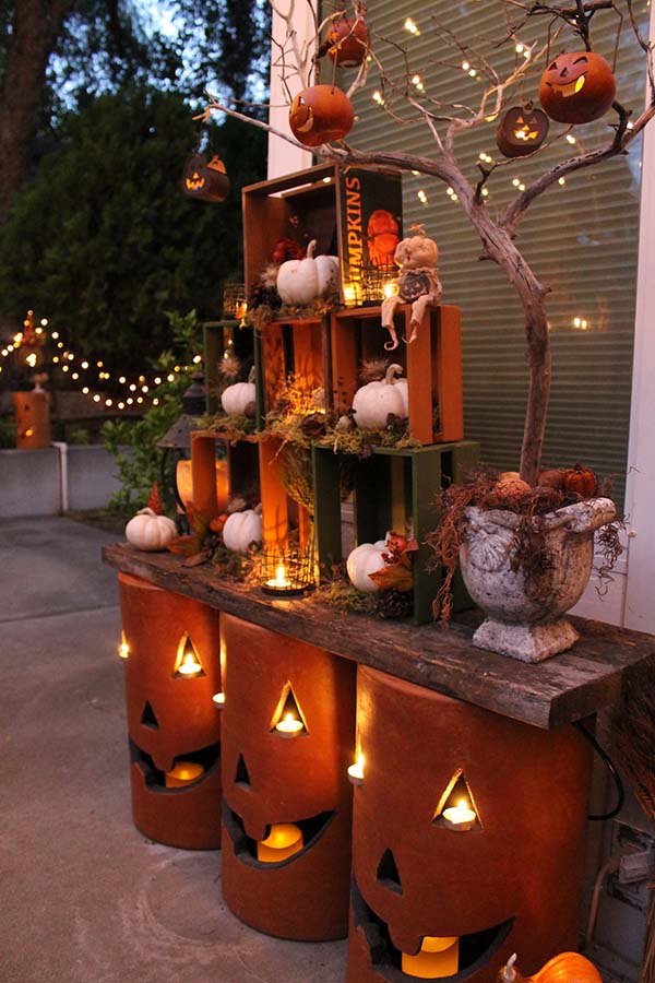 Nested crates and pottery pumpkins with LED candles and string lights would make your outdoor area shine!