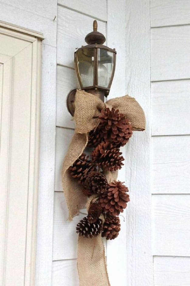 Don't forget to add something to wall-mount lights by your front door. Pinecones with burlap would be a perfect combo.