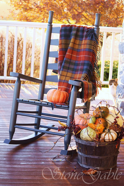 Plaid blankets are perfect additions to porch' seating furniture when evenings become colder and colder.