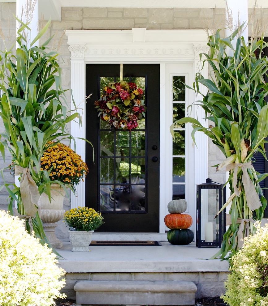 Add several pumpkins, lanterns, cornstalks and late blooms for subtle fall porch decor.