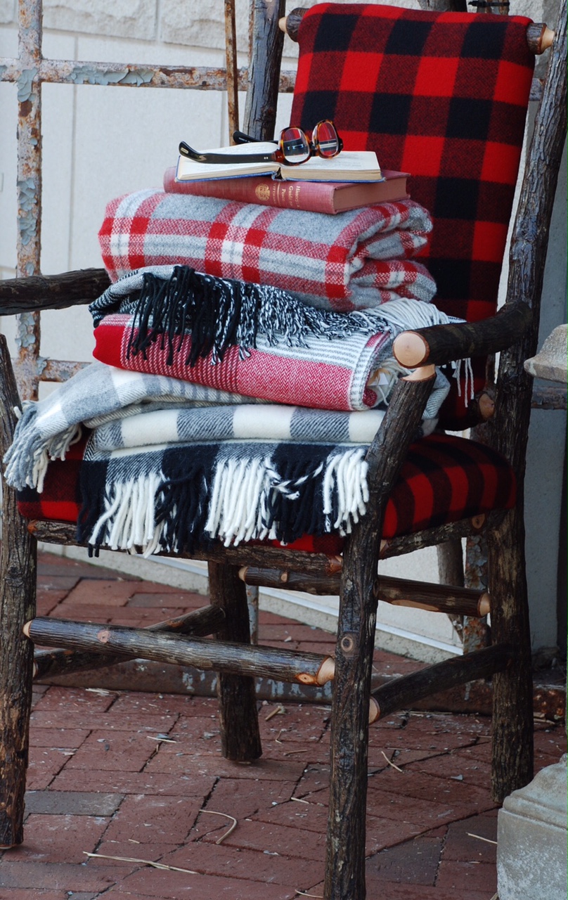 Throw a plaid blanket or a pillow over your porch furniture to make it cozy.