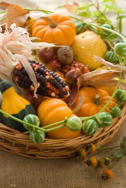 a basket with corn, pumpkins, gourds and husks for a long-lasting fall centerpiece to use more and more