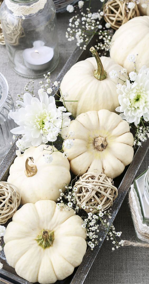 a beautiful fall centerpiece of a dark wooden box, vine balls, mini flowers, pumpkins and larger blooms is wow