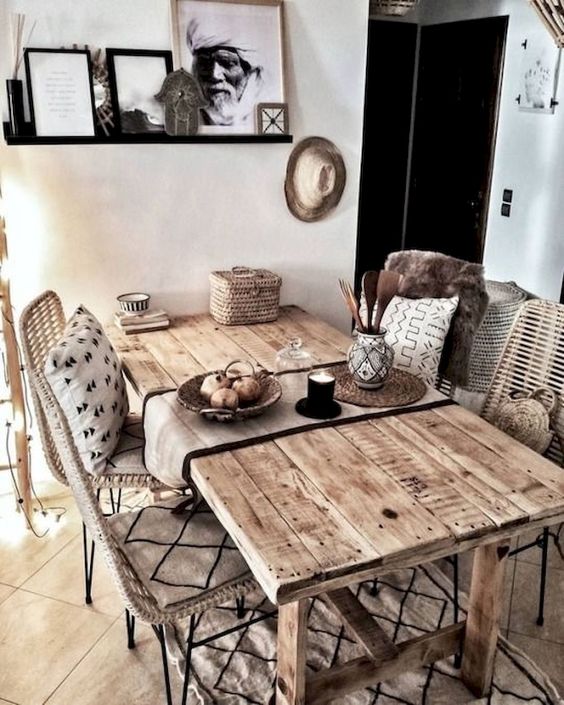 a boho rustic dining space with a rustic wooden table, wicker chairs, a basket for storage
