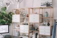 a large open and closed storage unit with gold framing and drawers is a stylish idea for a modern office with a touch of glam